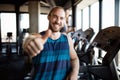 Portrait of happy man gesturing thumbs up at gym Royalty Free Stock Photo