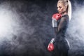 Battle ropes session. Attractive young fit and toned sportswoman working out in functional training gym doing exercise Royalty Free Stock Photo