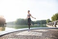 Portrait of fit young woman with jump rope in a park. Fitness female doing skipping workout outdoors on a sunny day. Royalty Free Stock Photo