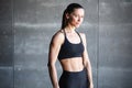 Portrait of a fitness smiling woman in black sportswear