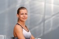 Portrait of fitness sporty smiling woman early in the morning city at sunrise