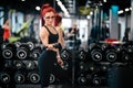 Portrait of fitness woman doing dumbbell workout at gym. attractive slim woman working out