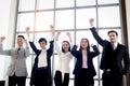 Portrait of five cheerful happy businesspeople, group of businessmen and businesswomen confident raising hands up to celebrate Royalty Free Stock Photo