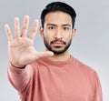 Portrait, five and hand for stop, Asian man and warning with serious expression against a grey studio background. Face