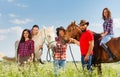 Portrait of five happy young horseback riders Royalty Free Stock Photo