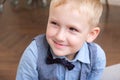 Portrait of a five-year-old blonde boy in a shirt, vest and bow tie Royalty Free Stock Photo