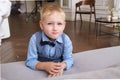 Portrait of a five-year-old blonde boy in a shirt, vest and bow tie Royalty Free Stock Photo