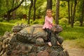 Portrait of a five year old girl sitting on a turtle Royalty Free Stock Photo