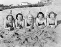 Portrait of five young women lying on the beach and smiling Royalty Free Stock Photo