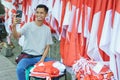 A portrait of a flag seller taking a photo