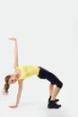 Portrait of a flexible young yoga girl in yelow top