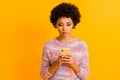 Portrait of focused afro american girl use smart phone read social media news share information wear stylish clothing