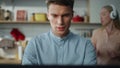 Portrait focused freelancer working home while blond wife dancing on backdrop