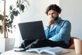 Focused business man using laptop sitting on beanbag chair