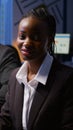 Portrait of focused smiling african woman sitting at desk in company office meeting room