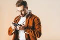 portrait of focused stylish man looking at photo camera in hands Royalty Free Stock Photo