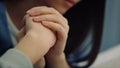 Portrait focused woman holding little kid arm. Beautiful female express caress