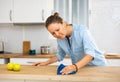 Focused woman cleaning kitchen table at home Royalty Free Stock Photo