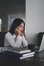 Focused young businesswoman looking at screen of computer laptop and feeling tired after unproductive work. Royalty Free Stock Photo