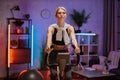 Portrait of focused young female wearing sport bra and using exercise bike. Royalty Free Stock Photo