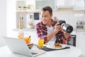 Portrait of food blogger with laptop and camera in kitchen Royalty Free Stock Photo