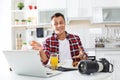 Portrait of food blogger with laptop and camera in kitchen Royalty Free Stock Photo