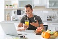 Portrait of food blogger with laptop in kitchen Royalty Free Stock Photo