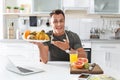 Portrait of food blogger with laptop in kitchen Royalty Free Stock Photo