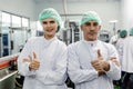 Portrait of food factory worker male and female thumbs up happy enjoy working with clean hygiene dressing. good quality products