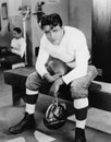 Portrait of football player in locker room