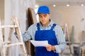 Portrait of foreman with documentation in apartment, renovation works