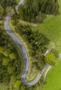 Portrait format of romantic Lechtal Alps pass road which winds through the green forest