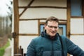 Portrait of a forty year old handsome man with glasses posing at the Belgian countryside