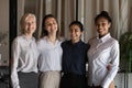 Portrait of four attractive businesswomen stand in row hug smile Royalty Free Stock Photo