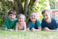 Portrait Of Four Brothers And Sisters Lying In Garden At Home