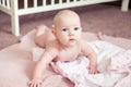 Portrait of four months old baby girl lying on tummyafter taking a bath, at home.