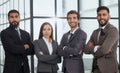 Portrait of four office workersr arms over their chest. Royalty Free Stock Photo