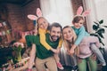 Portrait of four positive overjoyed idyllic people have fun hold piggyback kids house indoors