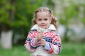 Portrait four-year girl with bouquet white dandelions in the hands of