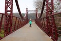 Portrait of a four year old caucasian girl posing on autumn red bridge Royalty Free Stock Photo