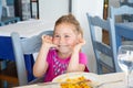 Little girl making fun with paella dish in restaurant Royalty Free Stock Photo