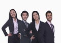 Portrait of four young business people looking at the camera, three quarter length, studio shot