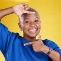 Portrait, frame and hand gesture with a black woman in studio on a yellow background feeling happy. Hands, smile and Royalty Free Stock Photo