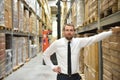 portrait friendly businessman manager in suit working in the warehouse of a company