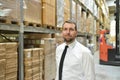 portrait friendly businessman manager in suit working in the warehouse of a company