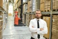 portrait friendly businessman manager in suit working in the warehouse of a company