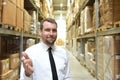 portrait friendly businessman manager in suit working in the warehouse of a company