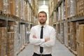 portrait friendly businessman manager in suit working in the warehouse of a company