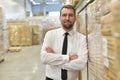 portrait friendly businessman manager in suit working in the warehouse of a company