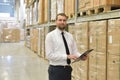 portrait friendly businessman manager in suit working in the warehouse of a company - control of inventories Royalty Free Stock Photo